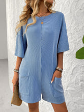 Model in sky blue Breezy Bold Romper at a stylish brunch.