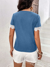 Back view of model in a sky blue Lace Detail V-Neck Short Sleeve T-Shirt, highlighting the delicate wavy lace trim on the sleeves and relaxed fit.