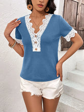 Side profile of model in a sky blue Lace Detail V-Neck Short Sleeve T-Shirt, showing off the delicate lace-trimmed sleeves and soft, relaxed fit.