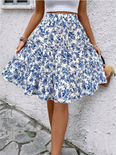 Sky blue Florévyn Midi Skirt with floral print, frill tiers, and ruffled hem styled with white tube top
