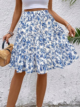 Side view of sky blue Florévyn Floral Print Midi Skirt with decorative waist tie, frill tiers, and ruffled hem