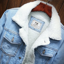 Close up Sky blue Denim jacket with white sherpa lining on a wooden surface