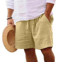 Solivaro men's dark khaki cotton relax fit adjustable waist shorts styled with straw hat, front view.