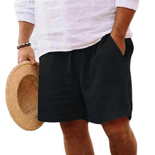 Solivaro men's black cotton relax fit adjustable waist shorts styled with straw hat, front view.