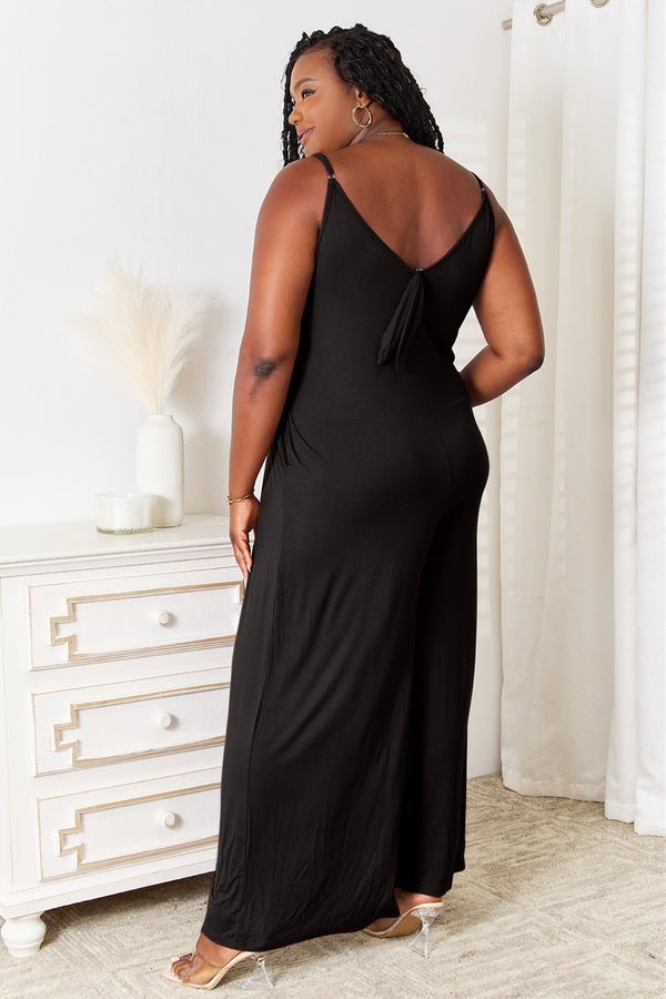 Close-up of the adjustable back tie detail on the Black Solvara Balance Jumpsuit, styled in a chic bow.