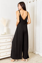 Close-up of the adjustable back tie detail on the Black Solvara Balance Jumpsuit, styled in a chic bow.