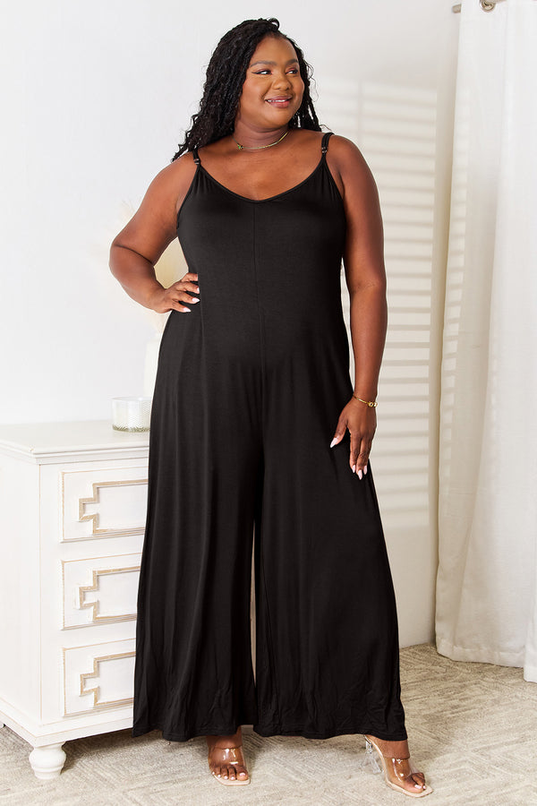Model radiates elegance in the Solvara Balance Jumpsuit, featuring soft rayon fabric and delicate spaghetti straps.