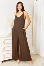 Model styles Mocha Solvara Balance Jumpsuit with boho jewelry and open-toe heels for a patio brunch.