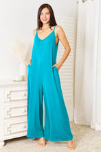 Softly shimmering Sky Blue Solvara Balance Jumpsuit drapes gracefully over the model’s frame.