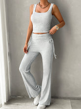 Model lounging on sofa in light gray Solvenza MoveEase Lounge Set with cozy accessories.