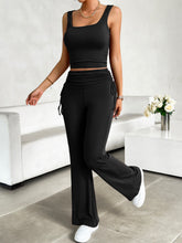 Black Solvenza MoveEase Lounge Set styled for workout, paired with trainers and hair up.