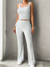 Model in light gray Solvenza MoveEase Lounge Set posing against a wall, relaxed casual style.
