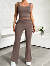 Model lounging on sofa in taupe Solvenza MoveEase Lounge Set with cozy accessories.