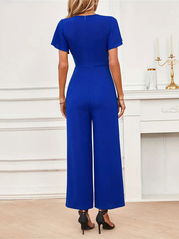 Back view of Navy Soralia DrapeSuit, highlighting draped fit, waist tie detail, and flowy silhouette, perfect for cocktail evenings.