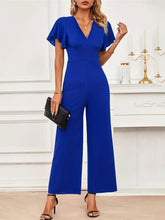 Model wearing Navy Soralia DrapeSuit, accessorized with gold hoops and nude heels for a casual-chic day out.