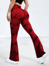 back view stretching pose in spectraflow bootcut leggings burgundy