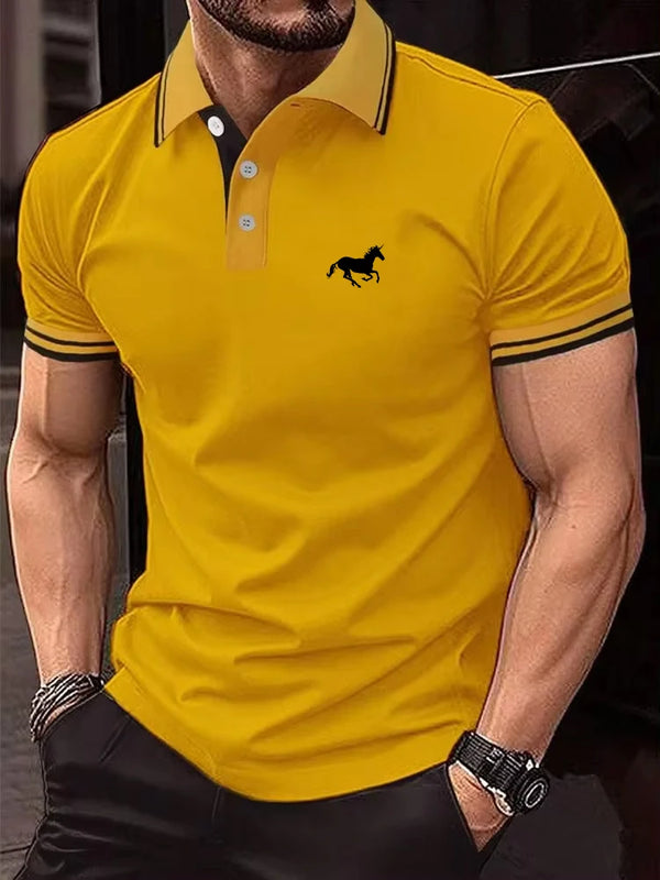 Model wearing gold Stallion Crest Luxe Polo with black stallion logo and contrast sleeve trim