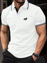 Model in white Stallion Crest Luxe Polo with bold black stallion logo and black trim sleeves
