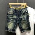 Front view of StoneRidge Distressed Vintage Skinny Jean Shorts in dark blue on hanger.