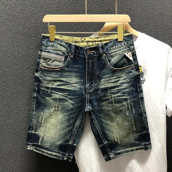 Front view of StoneRidge Distressed Vintage Skinny Jean Shorts in dark blue on hanger.
