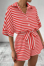 Woman in strawberry Striped Collared Tie Waist Romper styled with accessories for a laid-back chic.