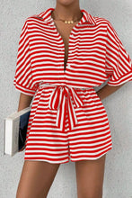 Model wearing LineaVerra™ Strawberry Romper with sandals and hoop earrings.