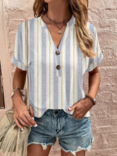Model wearing Printed Notched Short Sleeve Blouse in stripe with relaxed fit