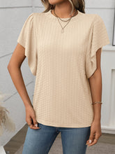 Model wearing a Round Neck Flutter Sleeve T-Shirt in tan, styled with white jeans and hoop earrings for a casual-chic daytime look.