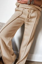 Close up of pants adjustable waist detail in tan kalorene zip up top and pants set