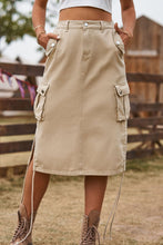 Close-up of Tan Rovelle Cargo Skirt with hands in side pockets