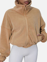 tan turtleneck zip up jacket front view hand in pocket