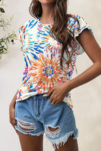 Model smiling in tangerine printed t-shirt with round neckline