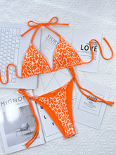 Tangerine leopard print halter neck tie side bikini set front flat lay view 