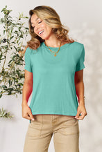Model wearing Full Size Round Neck Short Sleeve T-Shirt in soft teal