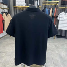 TexturaLoom Men’s Embossed Letter Polo Black Back View on Hanger.
