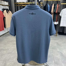 TexturaLoom Men’s Embossed Letter Polo Blue Back View on Hanger.