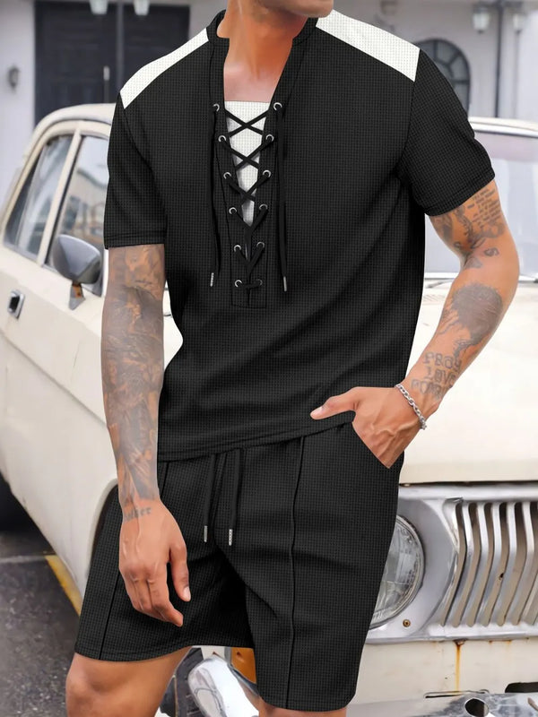 Men's black Valtren WaffleEdge lace-up waffle knit top and shorts set, front view of model sitting on an antique Bentley in a mansion driveway.