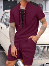 Men's burgundy Valtren WaffleEdge lace-up waffle knit top and shorts set, front view of model sitting on an antique Bentley in a mansion driveway.