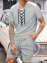 Men's gray Valtren WaffleEdge lace-up waffle knit top and shorts set, front view of model sitting on an antique Bentley in a mansion driveway.