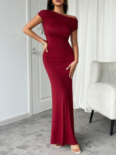 Side view of model in burgundy Vareliya Ruched Maxi Dress with fitted ruching and one-shoulder neckline.