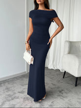 Dark blue Vareliya Ruched Maxi Dress styled for dinner date with metallic clutch and stilettos.
