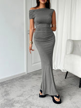 Side profile of model in gray Vareliya Ruched One-Shoulder Maxi Dress highlighting draped ruching and sleek fit.