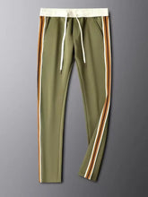 Front view close-up of Varnox LuxeTrak pants in army green, highlighting adjustable drawstring waist and pocket detail.