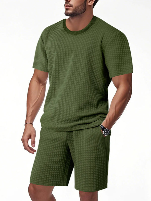 Men's army green textured top and shorts set, close-up with hand in pocket
