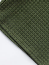 Close-up of shirt hem in army green