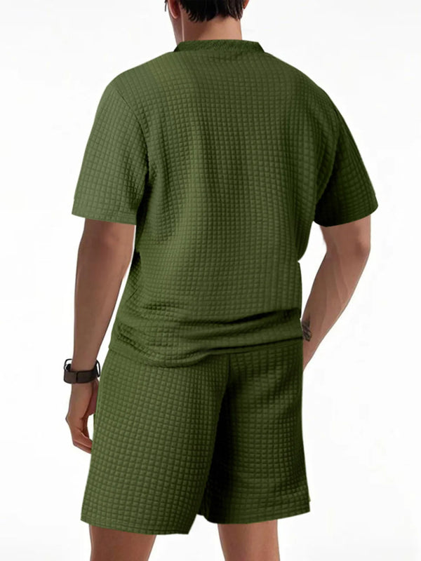 Back view of army green men’s Vayrix TextureFlex top and shorts set showcasing pique textured fabric and relaxed fit.