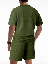 Back view of army green men’s Vayrix TextureFlex top and shorts set showcasing pique textured fabric and relaxed fit.