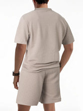 Back view of men’s khaki Vayrix TextureFlex top and shorts set showcasing pique textured fabric and relaxed fit