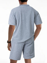 Back view of men’s light gray Vayrix TextureFlex top and shorts set showcasing pique textured fabric and relaxed fit