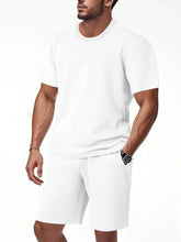 Men's white textured top and shorts set, close-up with hand in pocket